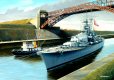 The mighty Kriegsmarine battleship Tirpitz passes under the iconic Levensau High Bridge over the Kiel Canal.